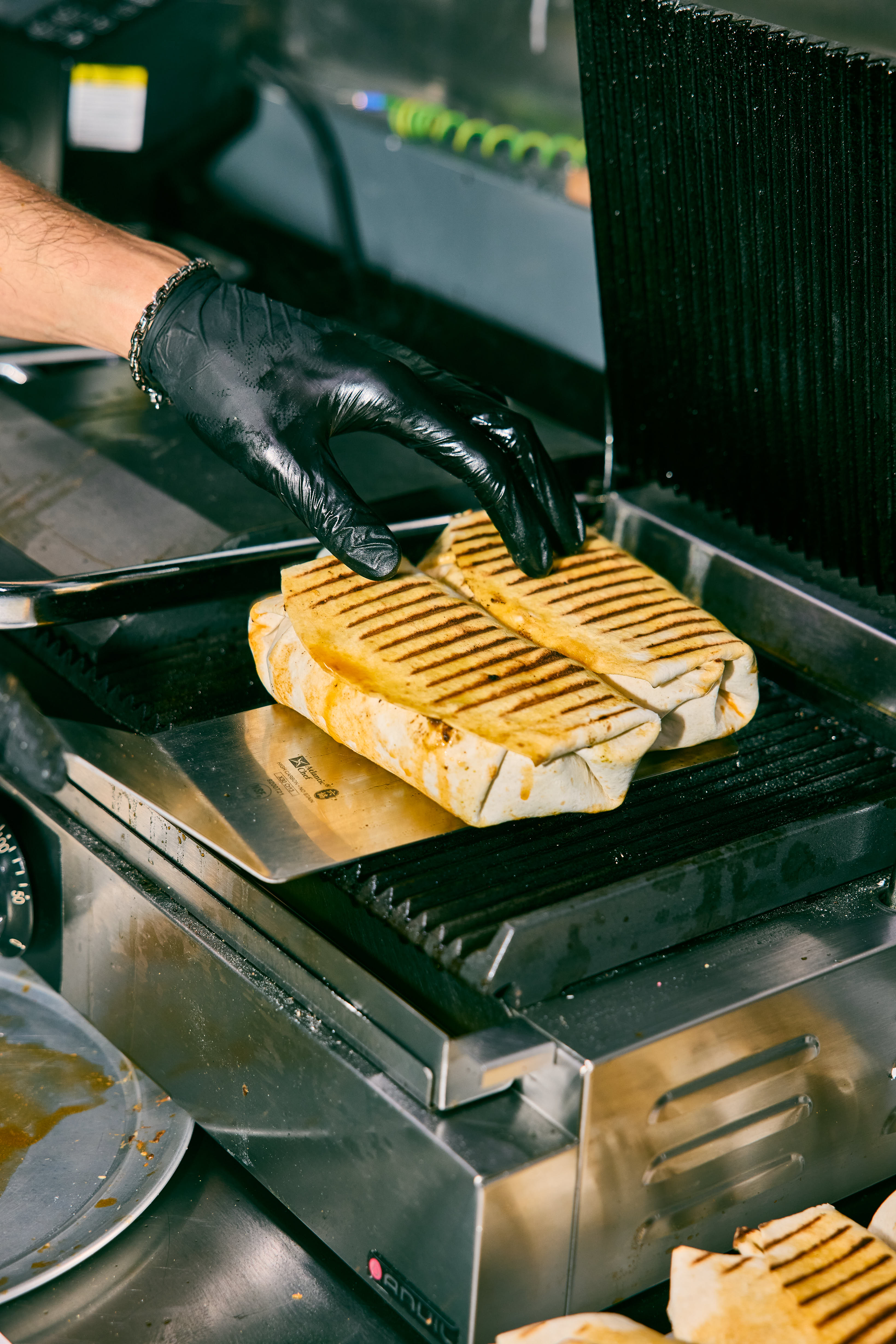 A Flatty being pressed on the grill
